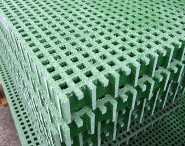panels of green gritted top GRP mini mesh panels, stacked on top of each other. The panels have fingers.