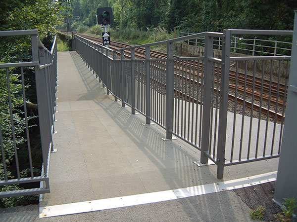 interlocking panels of pultruded plank to form a flat, grey pedestrian walkway