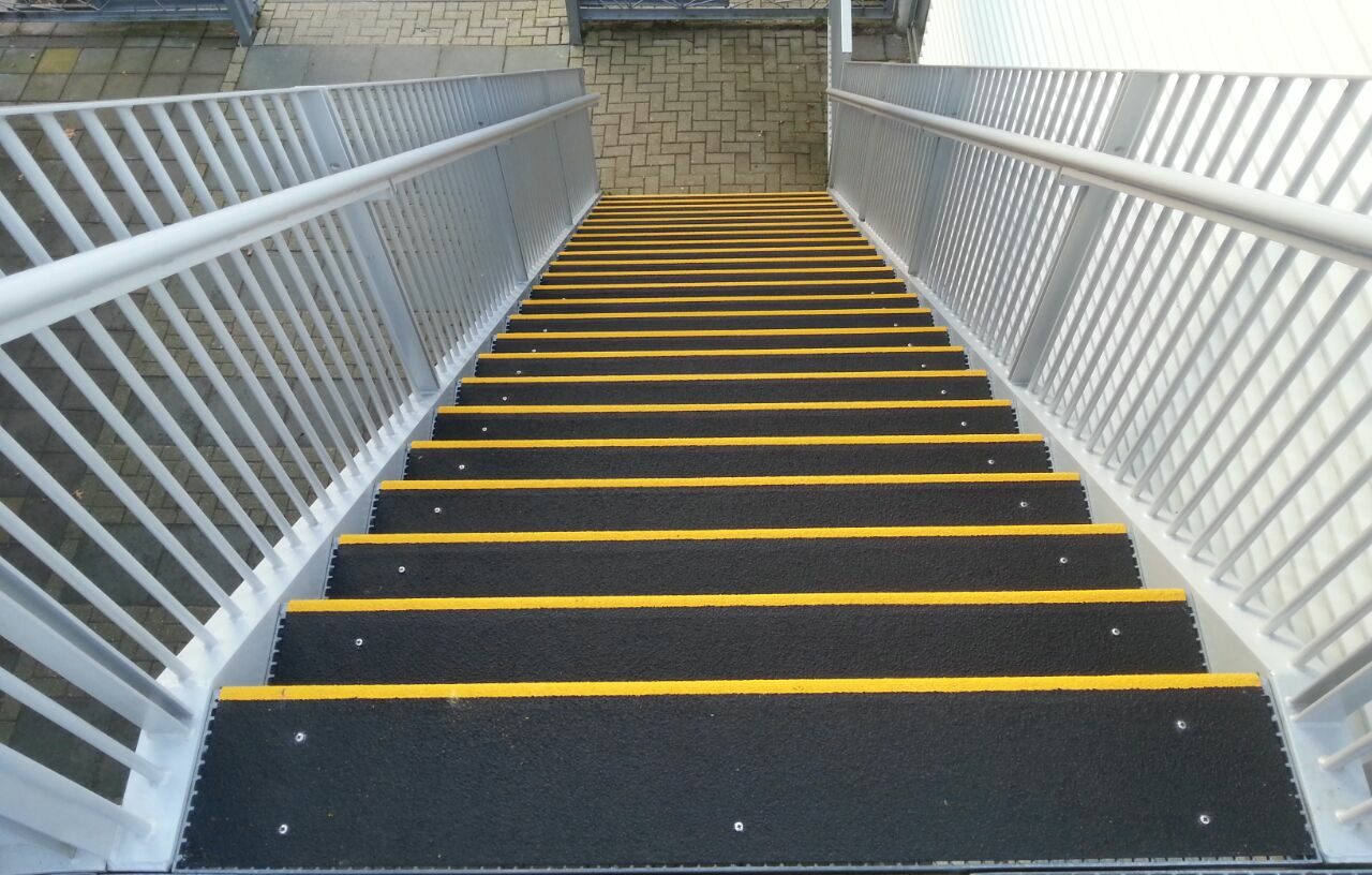 looking down from the top of a set of stairs covered in GRP anti-slip stair tread covers