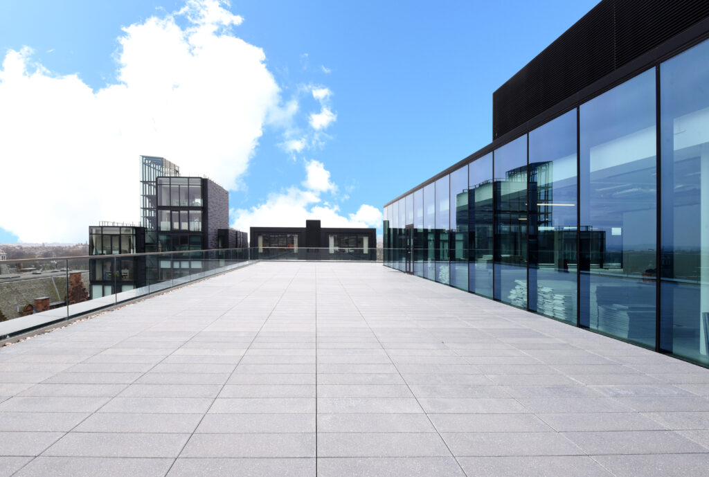 WPC decking used for an outdoor terrace on an office building with glass doors looking out on to it