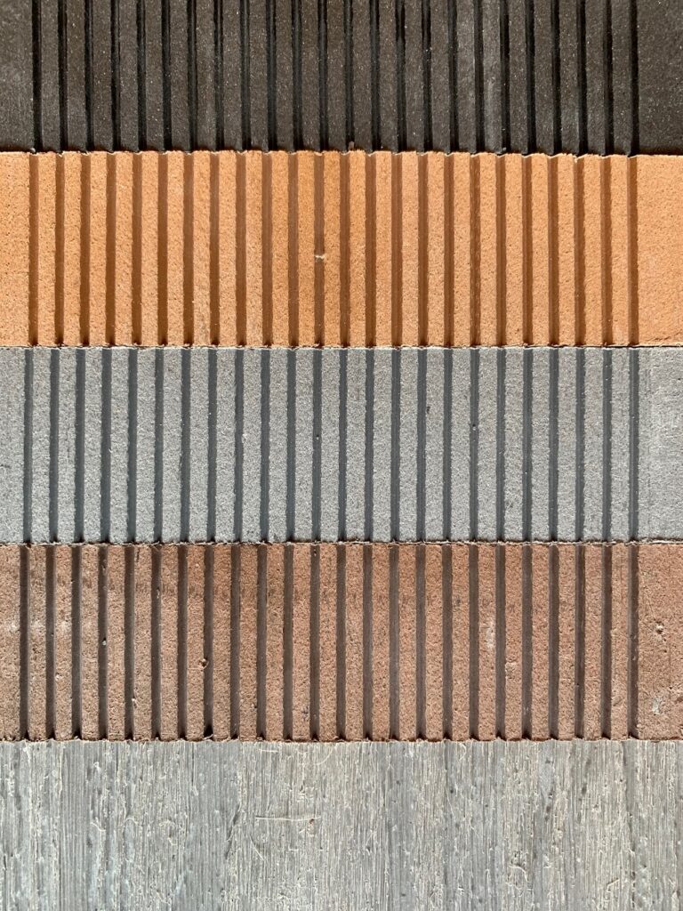 5 different colours shown on the underside of WPC decking panel strips including teak and grey