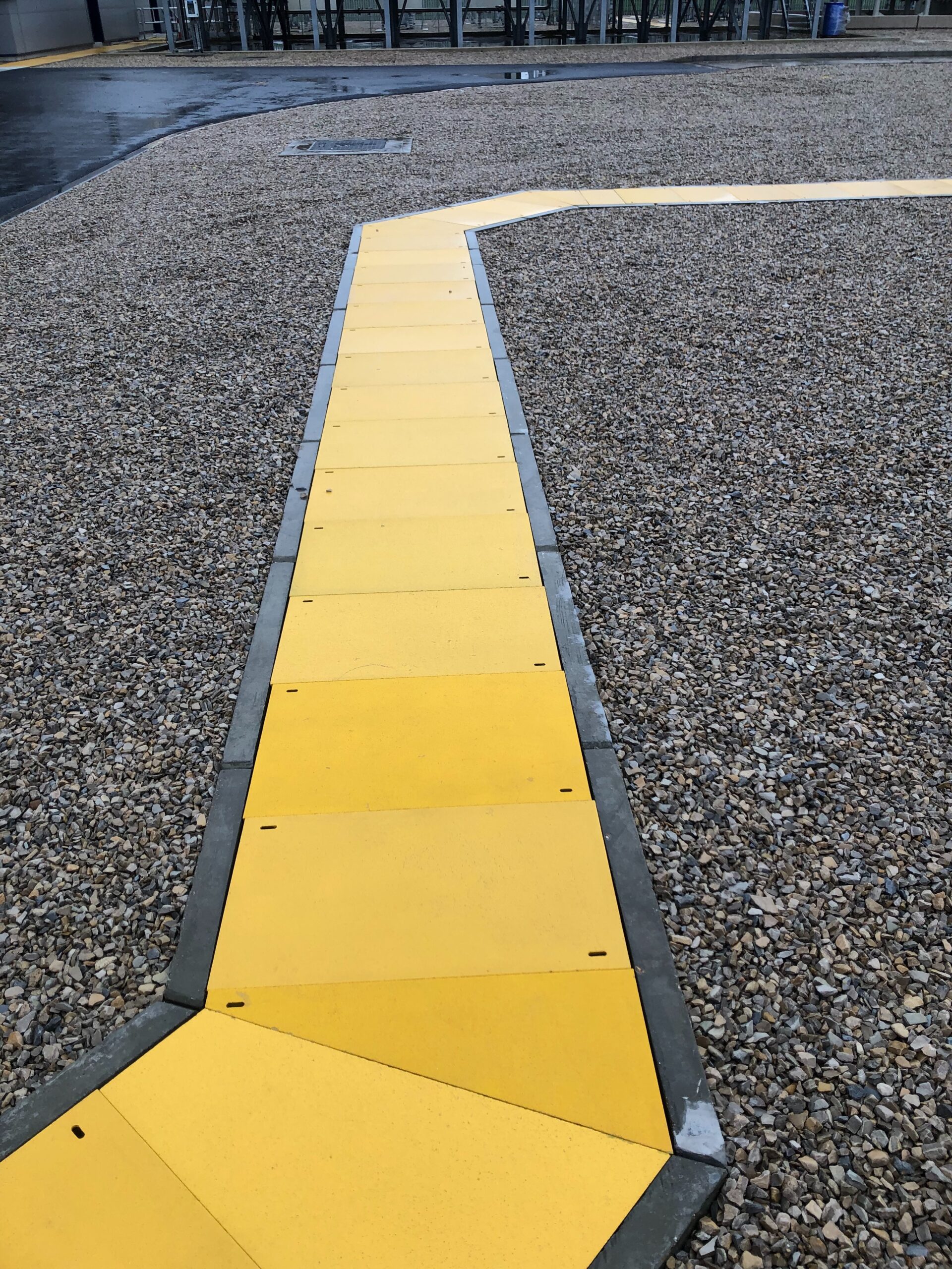 Yellow solid top GRP panels used to create a bright and anti-slip walkway through a site area