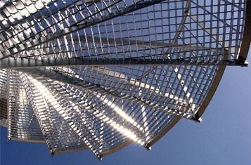 a stainless steel spiral staircase against a blue sky