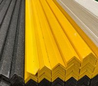 black, yellow and white anti-slip GRP nosing stacked on top of each other in stock
